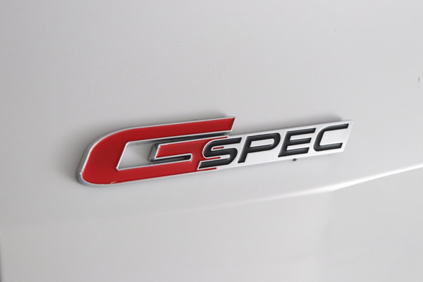 G-Spec badge on the rear of the white car
