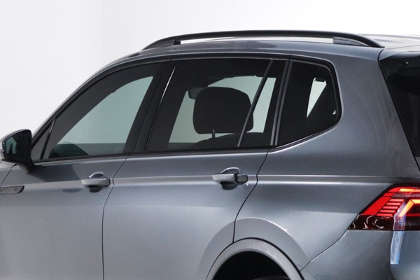 rear side view of an SUV with darkened privacy glass