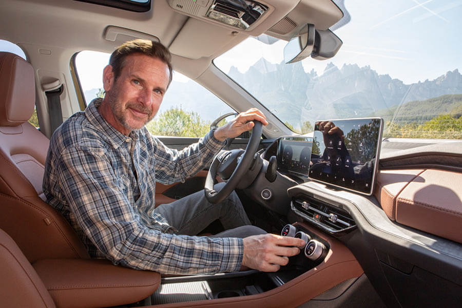 A man in the drviers seat of a Kodiaq SUV