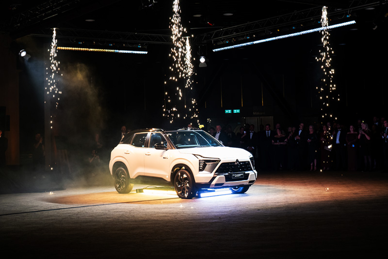 A white SUV under fireworks
