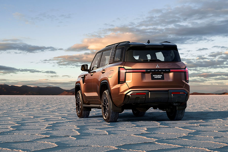Rear of a bronze Mitsubishi SUV parked in a desert
