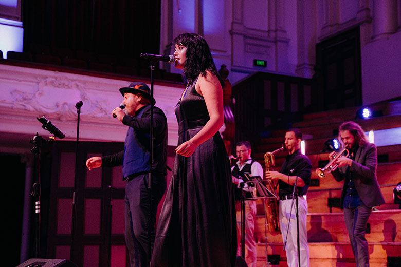 A singer on a stage in hall performing