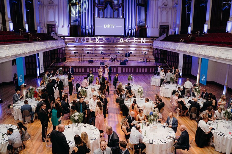 A concert hall with tables and chairs set-up
