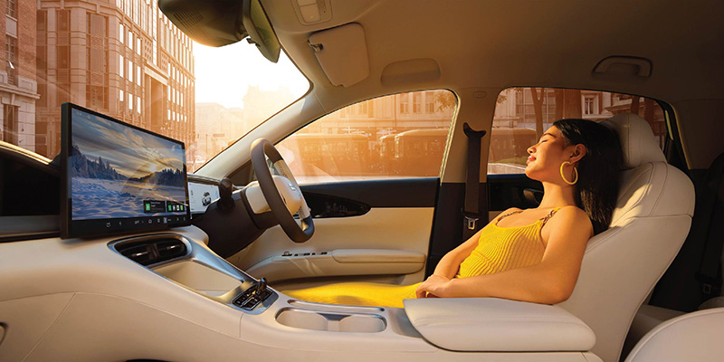 A woman sitting inside a Geely car