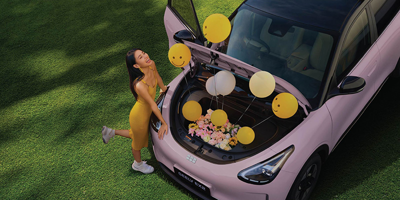high angle image of balloons coming out of the front trunk of a Geely EX2