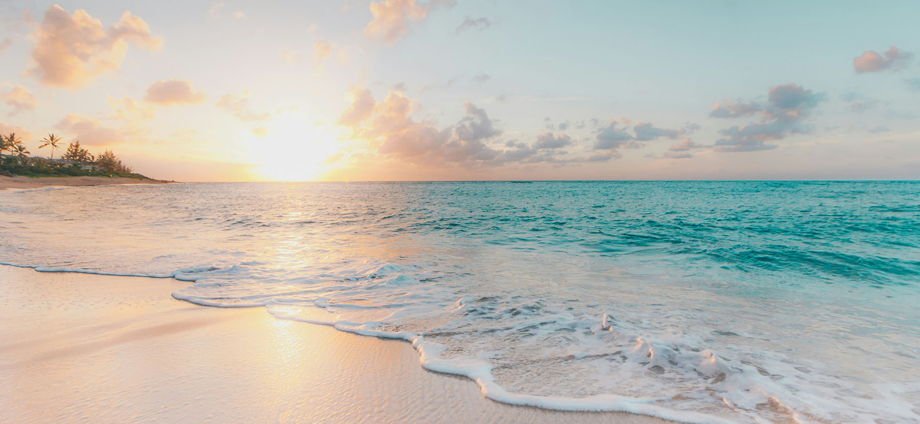 Photo of a beach with white sand during sunset