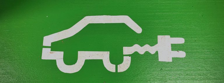 Electric vehicle icon painted on a green parking spot